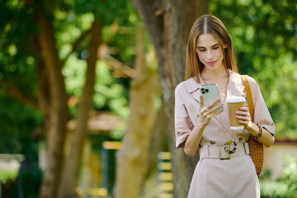 A cheerful young woman with anorexia takes a break in a lush green park, enjoying her coffee and connecting with the world around her.