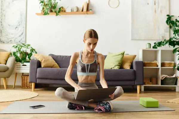 stock image In a serene living space, a young woman with anorexia engages in a home workout, balancing health and well-being daily.