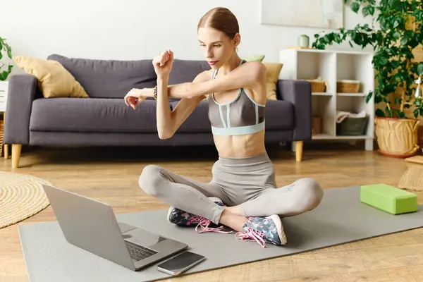 stock image In a cozy living room, a young woman with anorexia dedicates herself to daily home workouts, focusing on her fitness journey.