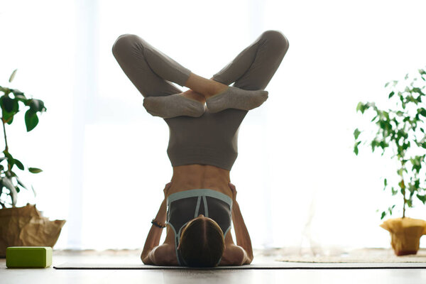 In a serene home environment, a young woman with anorexia persists with her workout routine, navigating her journey to wellness.