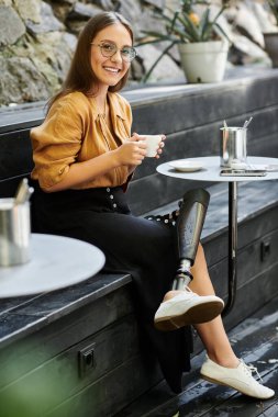 A woman with a prosthetic leg sips coffee at a modern cafe, smiling as she lives her vibrant lifestyle. clipart