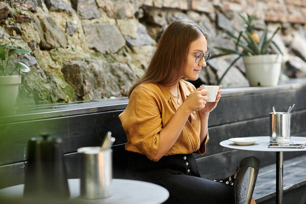 In a cozy cafe, a young woman sips coffee, embodying resilience and joy while embracing her daily life.