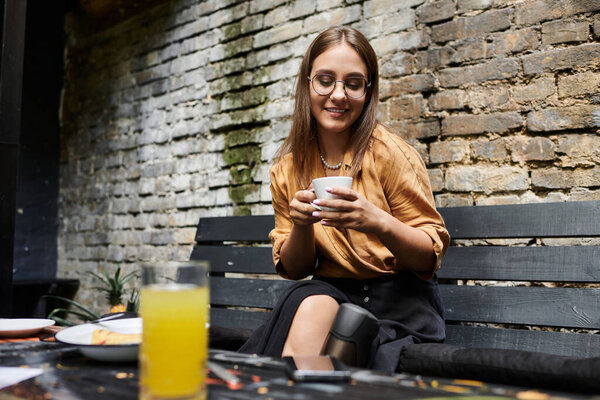 In a cozy cafe, a young woman with an artificial limb savors her coffee, embracing everyday life with a smile.