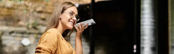 stock image A young woman smiles as she enjoys her coffee and chats in a lively cafe atmosphere.