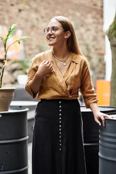 stock image A young woman smiling and engaging with her surroundings at a cafe, embracing life.