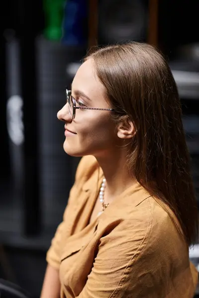 stock image In a cozy cafe setting, a young woman confidently showcases her daily lifestyle