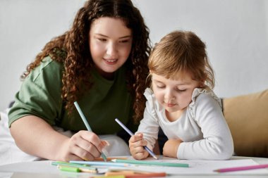 A mother and daughter enjoy art together, coloring and sharing moments of laughter and creativity. clipart