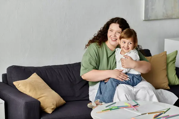 stock image A loving mother embraces her daughter as they engage in colorful arts and crafts together.