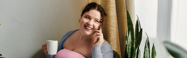 Cheerful woman talking by phone at home.