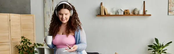 stock image Jolly woman with curly hair and comfy vibrant attire at home.