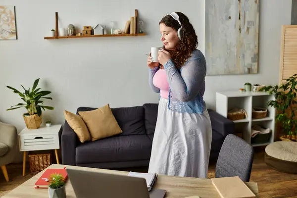 stock image Calm woman with curly hair and comfy vibrant attire at home.