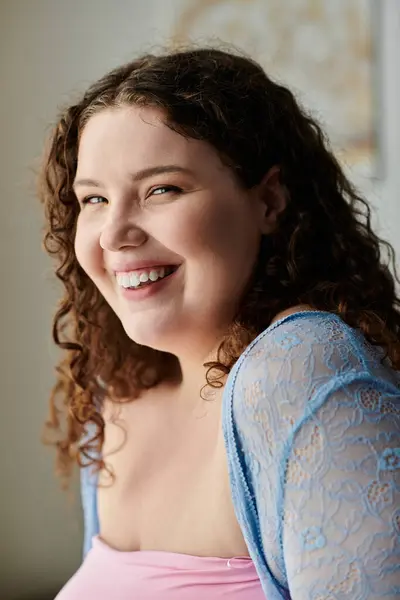 stock image Cheerful woman with dark hair and cozy attire spending time at home.