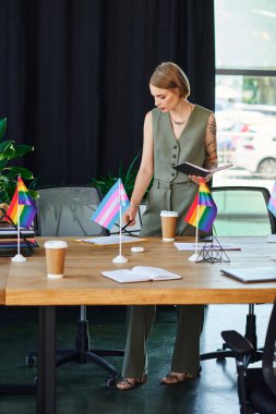 diverse woman discusses ideas while surrounded by pride flags and coffee cups. clipart