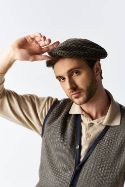 A dapper young man in a stylish vest and cap showcases his unique fashion sense with poise. clipart