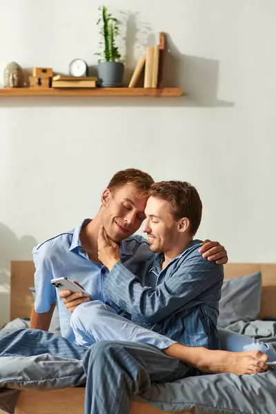 stock image A joyful couple in pajamas share a tender moment in their bedroom, wrapped in love and warmth.