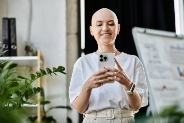 With a bright smile, a young bald woman dresses elegantly while interacting with her smartphone. clipart