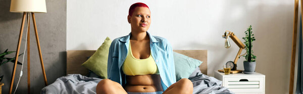 This young woman, radiating confidence, enjoys a moment of relaxation in her inviting bedroom.