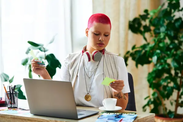 stock image The young woman is immersed in her creative tasks, surrounded by plants and colorful notes.