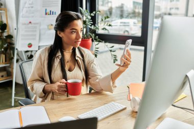 In a modern office, a young woman relaxes with a cup of coffee while using her smartphone. clipart