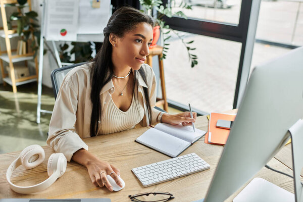 A young woman reflects thoughtfully while taking notes at her stylish office workspace.