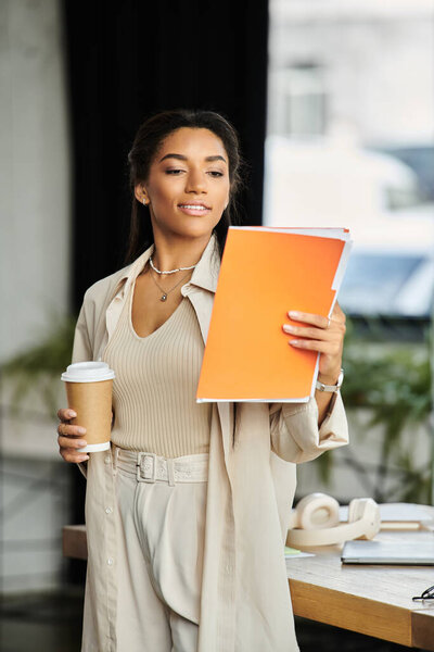 A young woman in professional attire engages with her documents while enjoying a coffee.