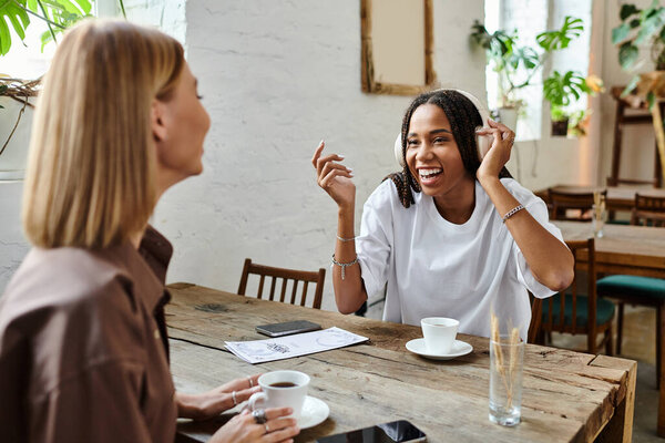 Радостный момент разворачивается, когда пара делится смехом за чашкой кофе в кафе, подчеркивая их связь.