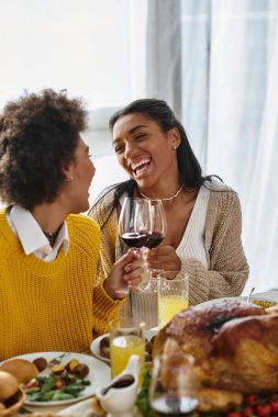 Friends gather around a beautifully arranged table, sharing laughter and delicious food together. clipart