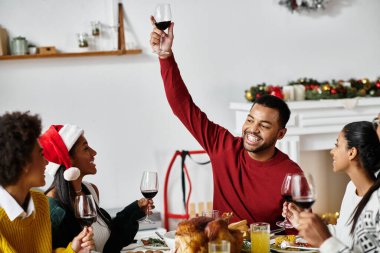 A group of friends raise glasses in a cheerful toast during their Christmas celebration. clipart