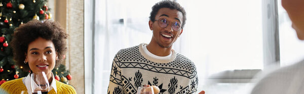 A group of friends enjoys Christmas festivities together, sharing laughter and happy moments.