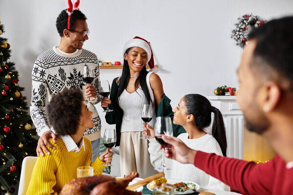 A lively gathering of friends celebrating Christmas, sharing laughter, food, and drinks.