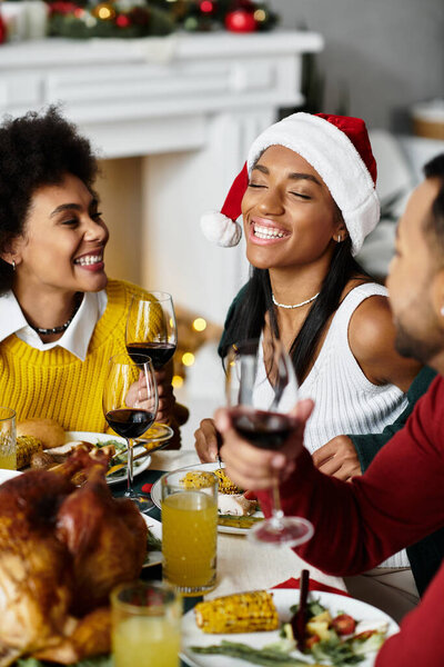 Friends gather to share laughter and tasty meals at their Christmas celebration.