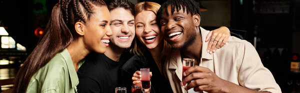 A group of young colleagues shares joy and laughter while toasting at a corporate gathering.