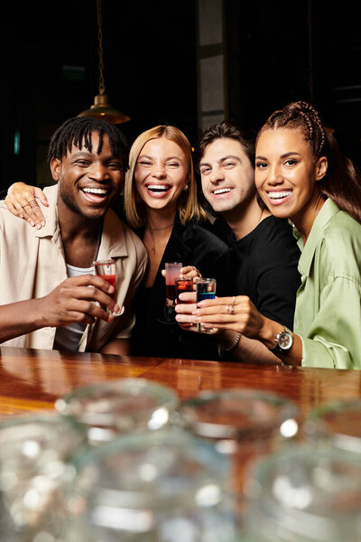 Colleagues celebrate success at a corporate gathering, sharing laughter and drinks together.