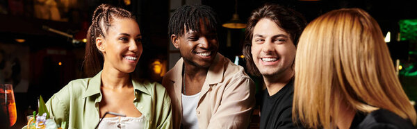 Young professionals engage in cheerful discussions while enjoying drinks at a corporate event.