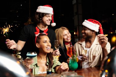 Young professionals gather joyfully, celebrating the holiday spirit with drinks and laughter. clipart