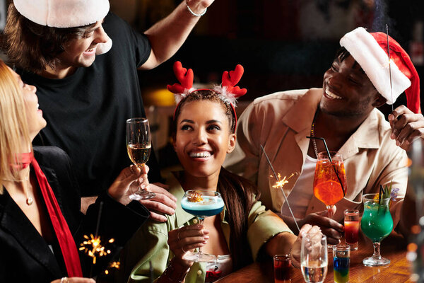 A diverse group enjoys a lively corporate gathering with colorful cocktails and joyous chatter.