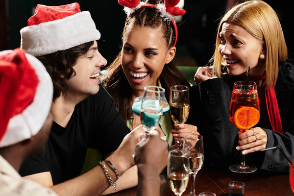 Colleagues joyfully raise their drinks, celebrating camaraderie at a festive corporate gathering.