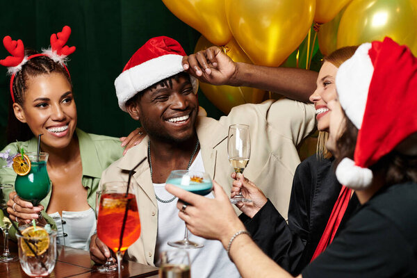 A lively gathering of young colleagues enjoying drinks and celebrating during a corporate event.