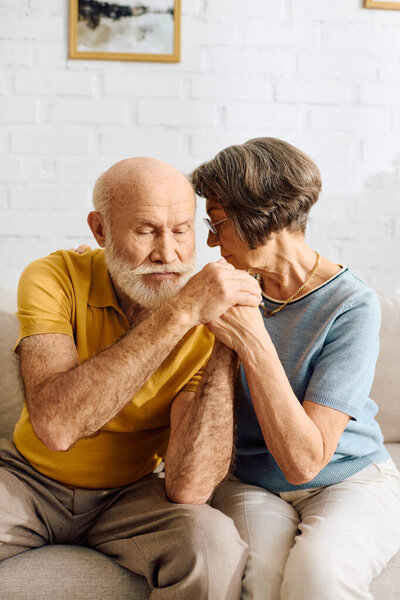 A caring wife supports her husband managing diabetes in their cozy home.