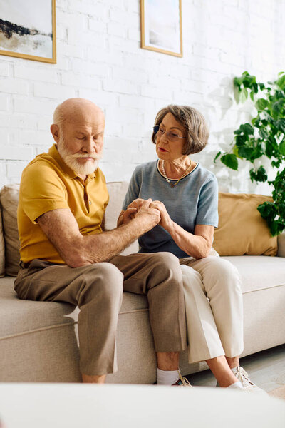A devoted wife assists her husband with diabetes while they sit together at home.