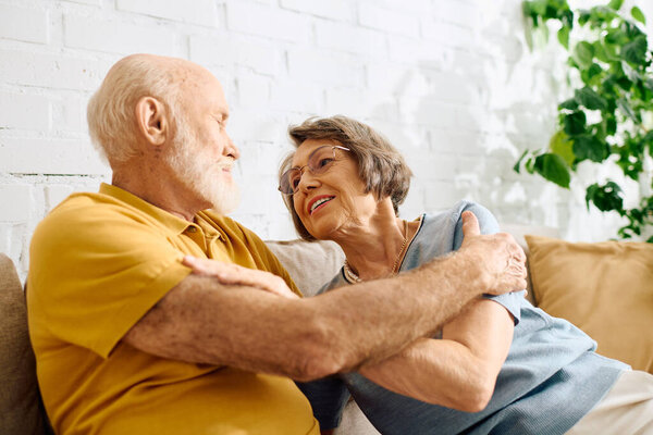 A devoted wife comforts her husband as they share a joyful moment at home together.