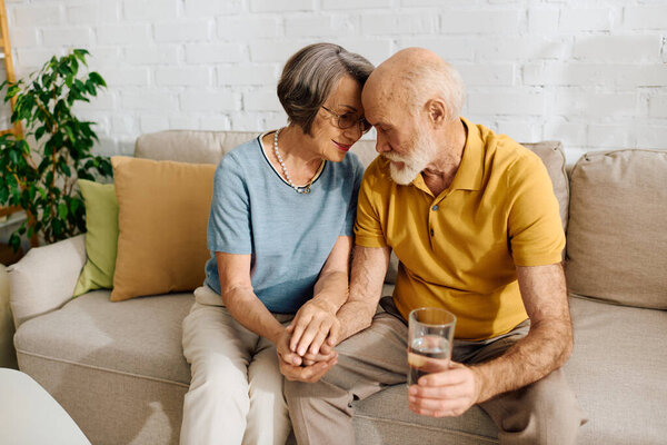 A devoted wife comforts her husband, managing diabetes, while sitting together at home.