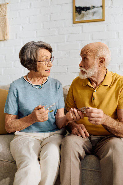 A senior man receives support from his devoted wife as they manage his diabetes at home.