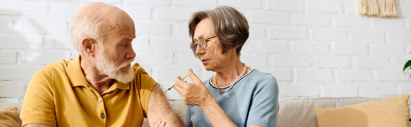 A supportive wife helps her husband with diabetes care in their warm and inviting home.