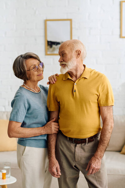 A loving couple finds comfort in each others presence at home while managing health challenges.