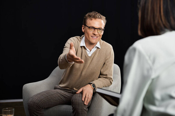 A professional journalist interviews a specialist, fostering a thoughtful discussion about current topics.