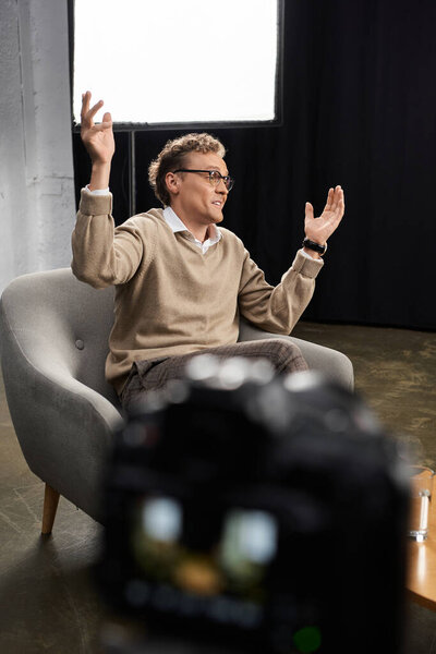 A middle-aged journalist engages in a thoughtful interview with a man, showcasing professional dialogue and expertise.