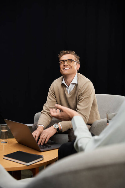 A middle-aged journalist passionately interviews a male expert in a contemporary studio, capturing insights.