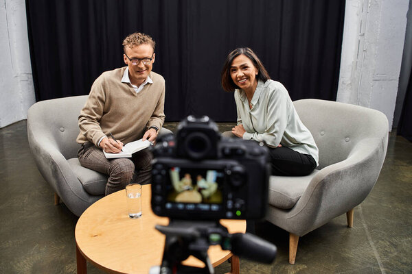 A journalist engages with a specialist, exchanging ideas in a warm and inviting atmosphere.