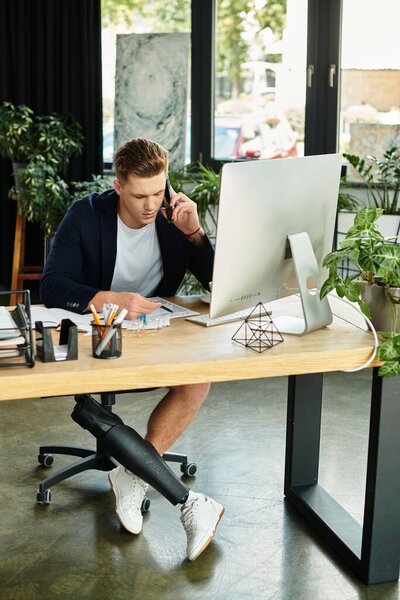 A determined young businessman with an artificial limb engages in work tasks at a stylish office.